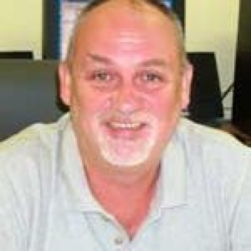 close up of man smiling wearing white shirt J. Hugh Ellis