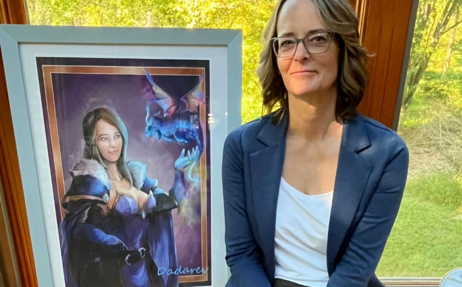 Dr. Michelle Colder Carras with portrait of her World of Warcraft avatar Dr. Michelle Colder Carras with portrait of her World of Warcraft avatar